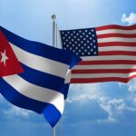 Flags from Cuba and United States flying side by side for important talks.